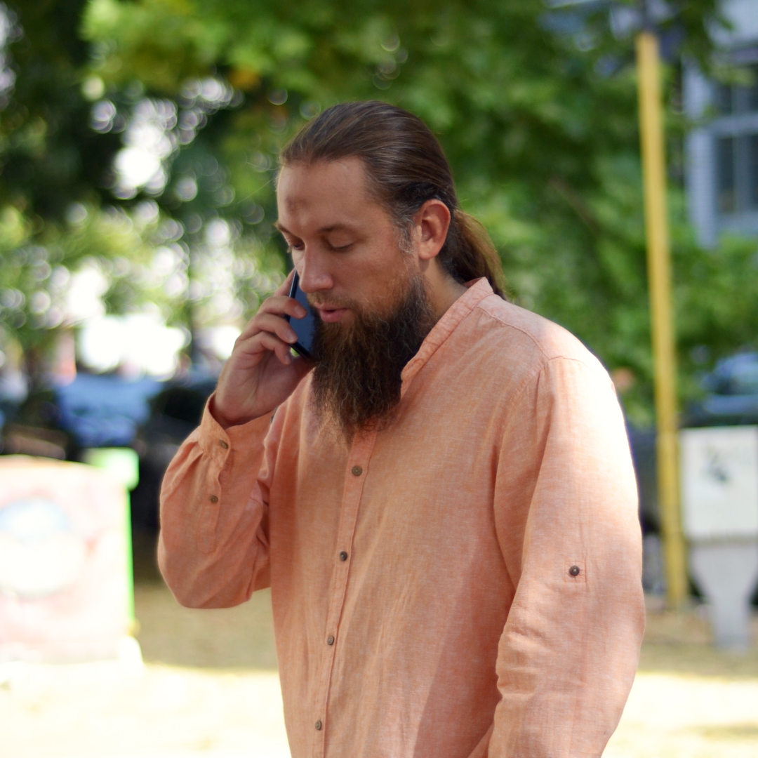 Zlatan Salkic in a vivid color shirt talking on the phone.